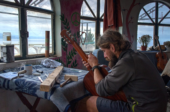 This is Christian. He travels Europe on his bike. He makes and repairs guitars, and is usually making something or playing his DIY fold-up guitar.