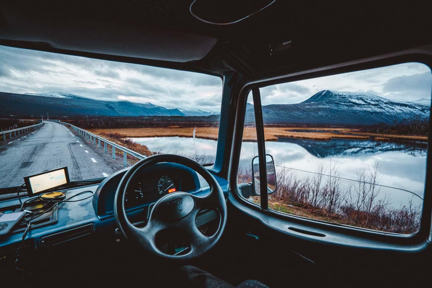 view of kebnekaise mountains from inside van cab through windows