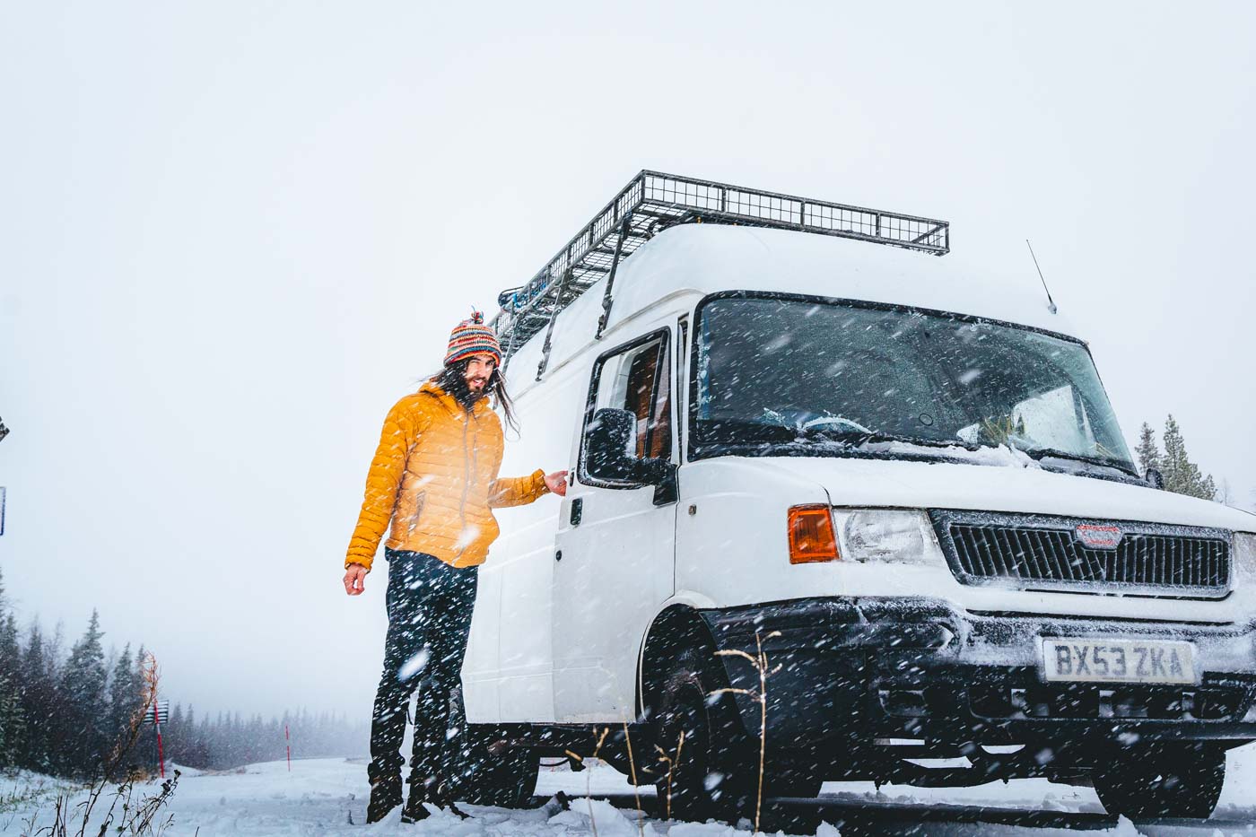 campervan driver struggling on snow road in Sweden