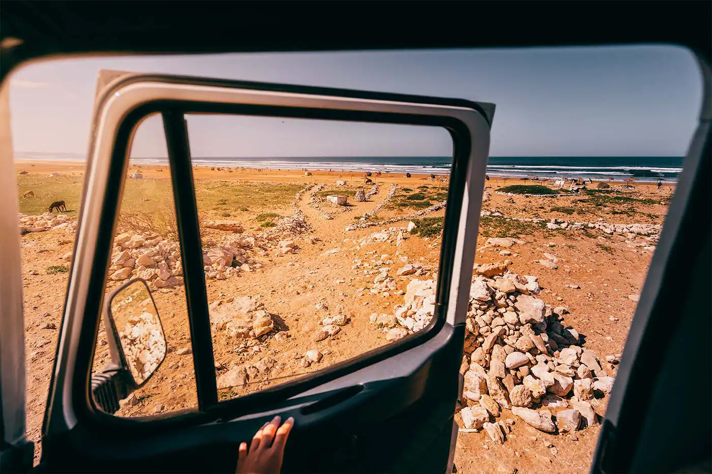 POV opening door onto beach in Sidi Kaouki