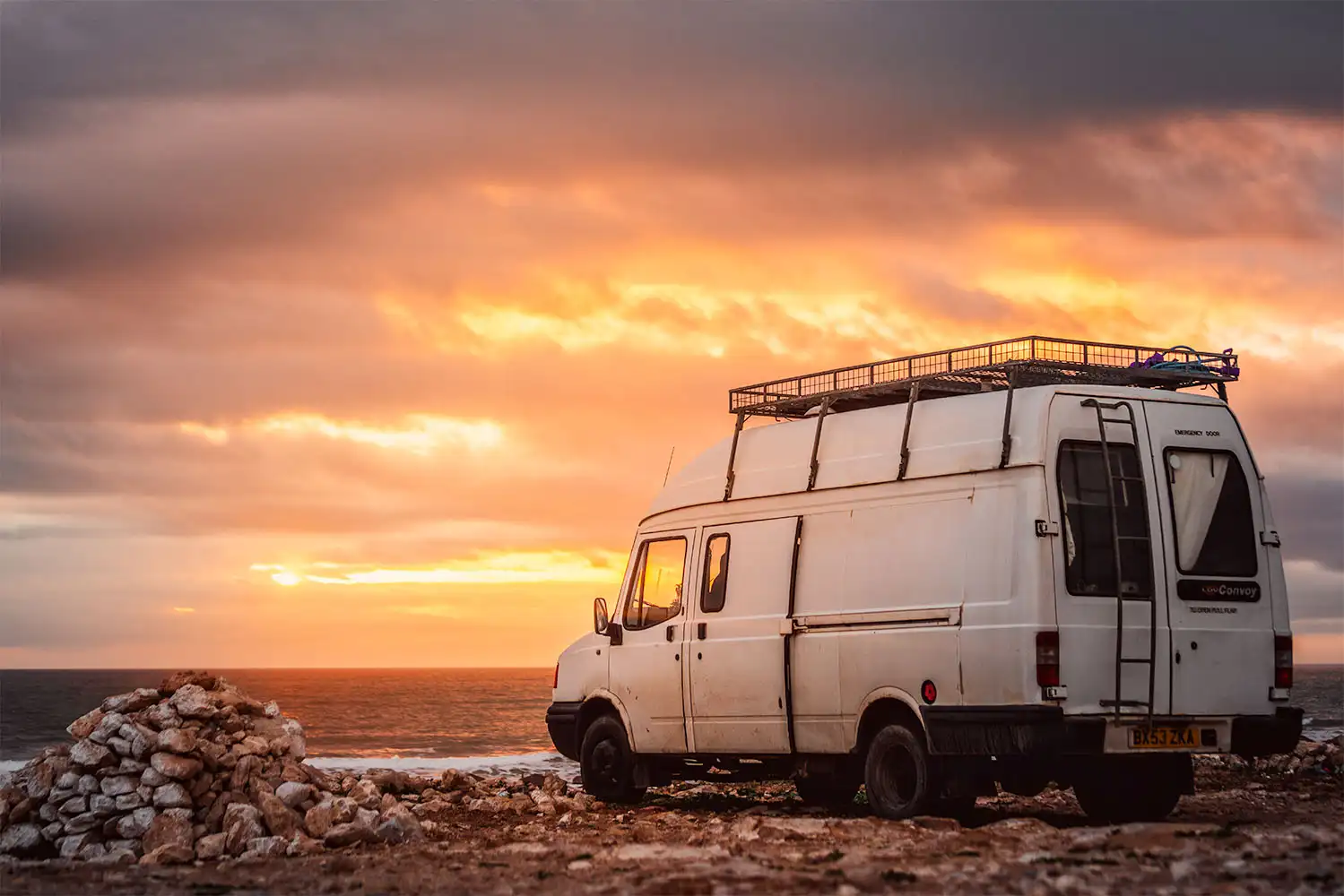 campervan at sunset with dramatic sky